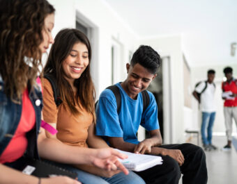 Teenager students reunited in the patio, laughing together